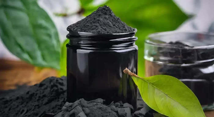 activated charcoal in a container with leaves in background