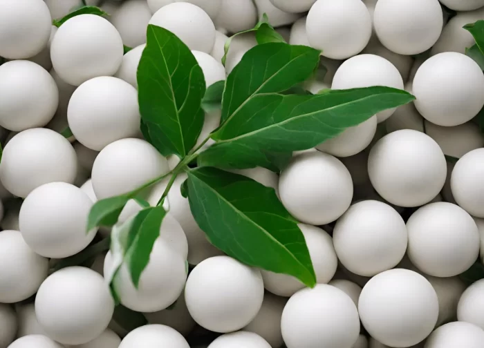 Alumina balls with green leaves in background