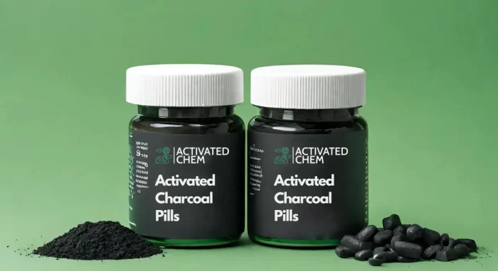 activated charcoal pills in a container with green background